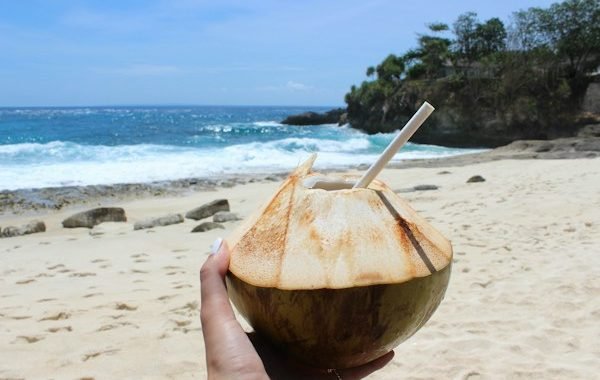 Fresh coconut hydration on Bali beach